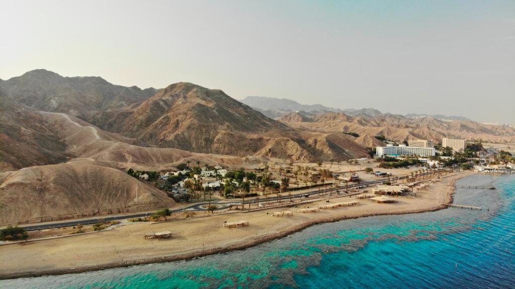 an aerial view of a beach next to the water at SPNI Eilat Field School in Eilat