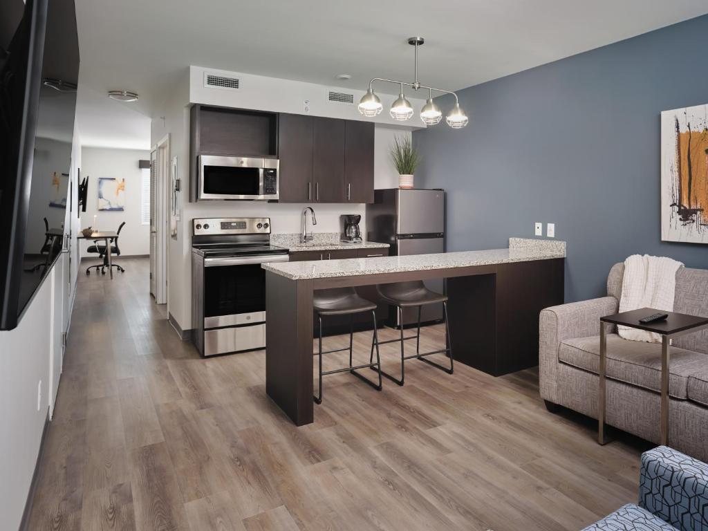 an open kitchen and living room in a apartment at stayAPT Suites North Little Rock in North Little Rock