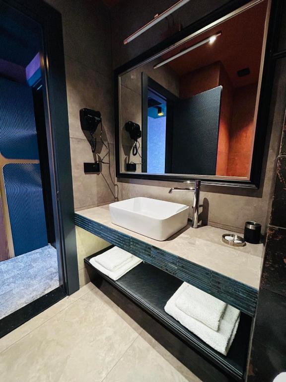 a bathroom with a sink and a mirror at Solomon in Kutaisi