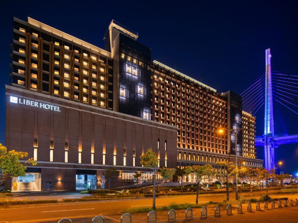 a large building with a hotel at night at LIBER HOTEL Osaka in Osaka