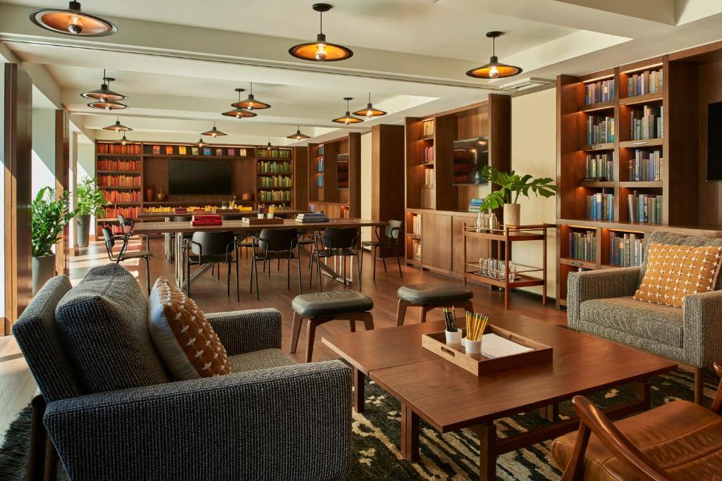 a living room with a table and chairs and a library at Arlo SoHo in New York