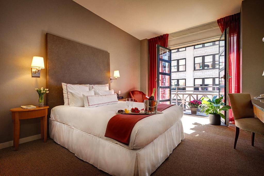 a hotel room with a large bed and a window at Hotel Giraffe by Library Hotel Collection in New York