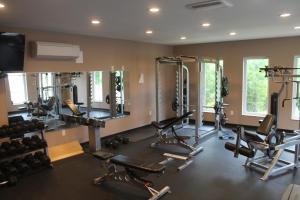 a gym with several treadmills and exercise bikes at Bell's Extended Stay and Suites in Saint Robert