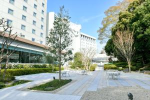 un parco con tavoli e sedie di fronte a un edificio di Narita Tobu Hotel Airport a Narita