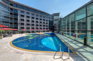 a large swimming pool in front of a building at Regal Airport Hotel in Hong Kong
