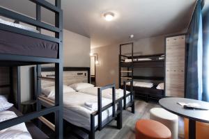 A bed or beds in a room at a&o Warszawa Wola