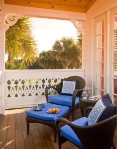 a porch with chairs and a table and a window at Port d'Hiver Bed and Breakfast in Melbourne Beach