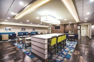 a conference room with chairs and a large table at La Quinta by Wyndham Baltimore South Glen Burnie in Glen Burnie