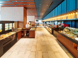 a buffet line in a restaurant with food on display at LIBER HOTEL Osaka in Osaka