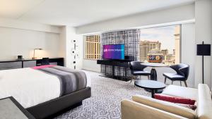 a hotel room with a bed and a large window at Planet Hollywood Resort & Casino in Las Vegas