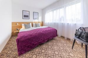 Un pat sau paturi într-o cameră la Haidinger's Boutique Domizil