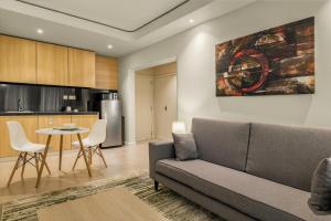 a living room with a couch and a table at Kozi Suites Nairobi Airport in Nairobi