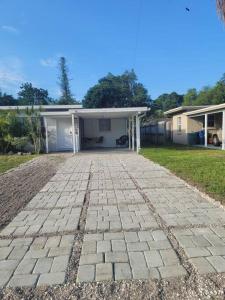 a brick driveway in front of a house at House by Siesta Key in Sarasota