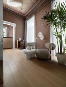 a living room with a white coffee table and a plant at Monument in Athens