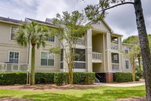 a house with trees in front of it at Mount Pleasant Condo with Pool and Bikes Near Beach! in Charleston