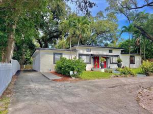 a white house with a red door at Private Guest House in Miami