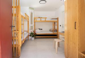 a room with a hallway with bunk beds at SPNI Eilat Field School in Eilat