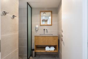 a bathroom with a sink and a mirror at SPNI Eilat Field School in Eilat +37 photos