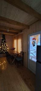 a living room with a christmas tree and a television at Wooden House Kopiti in Tbilisi City