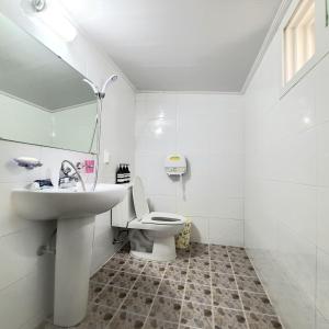 a white bathroom with a sink and a toilet at Hanok Raon in Gyeongju +37 photos