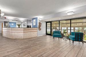 a lobby with two blue chairs and a bar at Club Wyndham Westwinds in Myrtle Beach +22 photos