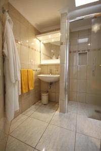 a bathroom with a sink and a shower and a mirror at Atlantic Beach Club in Playa del Ingles