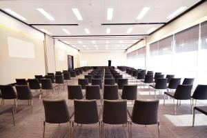 an empty room with chairs in a classroom at JetPark Auckland Airport Hotel in Auckland
