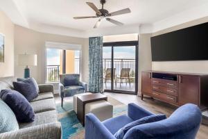 a living room with a couch and a flat screen tv at Hilton Grand Vacations Club Anderson Ocean Myrtle Beach in Myrtle Beach