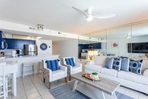 a living room with a couch and a table at Pelican's Landing in Destin