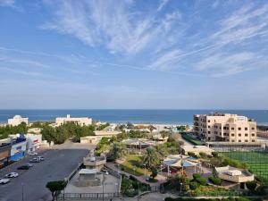 an aerial view of a city with the ocean at Ocean View Hotel Kuwait in Kuwait
