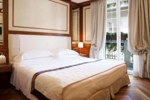 Ένα ή περισσότερα κρεβάτια σε δωμάτιο στο Hotel Manzoni