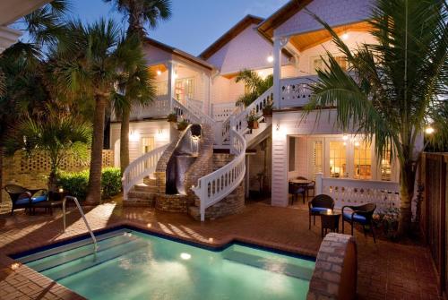 a house with a swimming pool in front of a house at Port d'Hiver Bed and Breakfast in Melbourne Beach