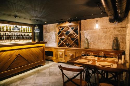a restaurant with a table and some wine bottles at Solomon in Kutaisi