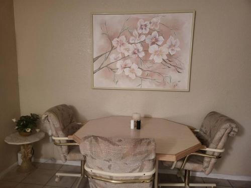 a dining room table and chairs with a picture on the wall at House by Siesta Key in Sarasota