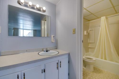 a bathroom with a sink and a toilet and a mirror at Rideau Oceanfront Motel in Ocean City