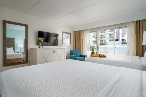 a white hotel room with a bed and a window at Princess Royale Oceanfront Resort in Ocean City