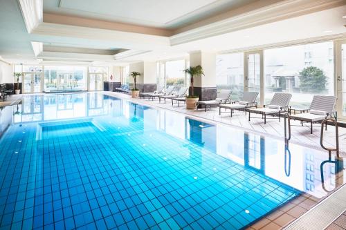 a large swimming pool with blue tiles in a building at The Ritz-Carlton Osaka in Osaka