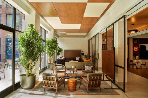 a living room with a couch and a table and chairs at Arlo SoHo in New York
